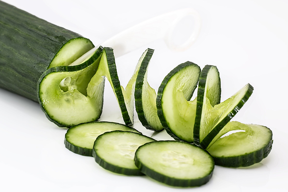 sliced cucumber on white table